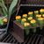 The Nordic Ware Jalapeno Roaster with stuffed jalapenos on a grill