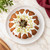 An overhead view of a cake baked in a Nordic Ware Original Bundt Pan, topped with icing.