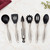 All of the utensils in the Norpro Silicone and Stainless Steel Kitchen Utensils Set on a marble kitchen counter with subtle gold veining.
