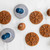 The Nordic Ware Snowflake cookie stamps with balls of dough and stamped cookie on a counter