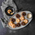An overhead view of mini Bundt cakes baked in the Nordic Ware 75th Anniversary Braided Mini Bundt Pan on a platter on a black table