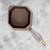 An overhead view of the FINEX 1 Quart Cast Iron Sauce Pot on a gray marble counter