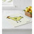 The Wet-It! The Lemon Chicken Swedish Cloth on a kitchen counter next to a basket of lemons
