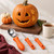 A carved pumpkin with a pretty vine etching and the Messermeister pumpkin carving tools set.