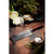 The Hammer Stahl Damascus Steel Nakiri Knife on a cutting board with ingredients