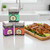 The Spicewalla Grill Lovers Collection stacked on a kitchen counter next to spice rubbed chicken thighs