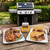 A Spicewalla Carolina Mustard BBQ Rub tin sits on a wooden table beside a platter of seasoned pork chops and a platter of grilled pork chops.