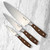 The 3 knives of the Messermeister Avanta Pakkawood Starter Knife Set on a marble counter