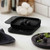 The black Rosti Mensura Kitchen scale weighing blackberries on a kitchen counter