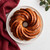 A cake baked in the Nordic Ware Swirl Bundt Pan, with a honey glaze.