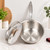 The 2-quart saucier is on a kitchen counter resting against a white backsplash.