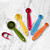 The individual measuring spoons on a marble counter