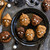 Decorated cakelets made with the Monster Mask cakelet pan on a Halloween decorated table