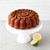 A cake baked in the Nordic Ware Citrus Twist Cake Pan on a cake stand