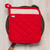 A Now Designs Superior Red Pot Holder on a skillet