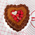 A decorated chocolate cake made in the Fat Daddio's 6 inch heart cake pan