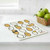 The Wet-It! Eggs and Hatchlings Swedish cloth on a kitchen counter with a basket of green apples