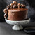 Chocolate skulls made in the Nordic Ware Skull Bites Cakelet Pan on an iced chocolate cake