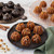 Mini cakes made in the Nordic Ware Lil pumpkins Cakelets pan on a plate and the pan upside down on a table
