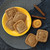 Cookies made with the Nordic Ware Fall Forest Springerle Cookie Stamps on a plate next to orange slices and cinnamon sticks