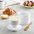 A Cafe Matte White Butter Bell Crock with the word buerre on the side with the lid off