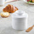 A Cafe Matte White Butter Bell Crock with the word butter on the side with the lid on