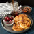 Pancakes made with the Nordic Ware falling snowflake pancake pan on a plate with cherries and chopped walnuts