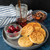 Pancakes made with the Nordic Ware falling snowflake pancake pan on a plate with cherries
