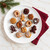 Decorated holiday tea cakes baked in the Nordic Ware Holiday Tea Cakes Pan on a white plate.