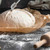 The Fox Run Stainless Steel Bread Lame scoring a ball of dough