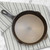 The Lancaster No. 8 cast iron skillet on a kitchen towel on a marble counter