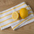 A Now Designs Lemon Yellow Stripe Dish Towel with lemons