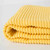 A closeup view of the Now Designs Ripple Lemon Yellow Dish Towel