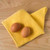 A Now Designs Ripple Lemon Yellow Dish Cloth with eggs