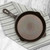 The Lancaster No. 6 cast iron skillet on a kitchen towel on a marble counter