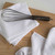 The Now Designs Ripple White Dish Cloths with a whisk