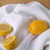 A Now Designs Ripple White Dish Towel with lemons