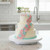 A decorated tiered cake on the Fat Daddios 12x2-inch Cake Decorating Turntable