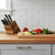 The Messermeister Avanata Damascus Knife Block set on a kitchen counter with cut veggies on a cutting board
