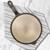 An overhead view of the Lancaster No. 8 Cast Iron Griddle on a kitchen towel on a marble counter