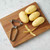 The Kitchen Basics Stainless Steel Vegetable Peeler with peeled potatoes