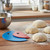 The Messermeister Silicone Bowl Scraper Set on a kitchen counter with portions of bread dough