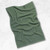 A Now Designs Ripple Elm Green Dish Towel laying on a counter