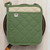 The Now Designs Superior Elm Green Pot Holder on a skillet