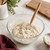 A Mrs. Anderson's Baking Dough Whisk in a bowl of sticky no-knead bread dough.
