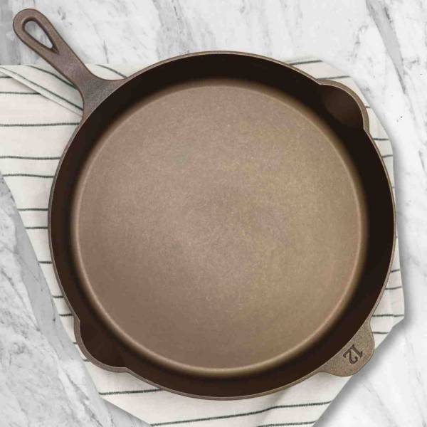 An overhead view of the Lancaster No. 12 Cast Iron Skillet on a marble counter