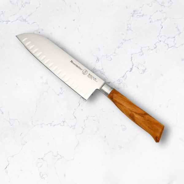 A Messermeister 7 inch santoku knife on a marble counter