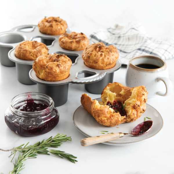 The Nordic Ware Grand Popover Pan with popovers and jam on a kitchen counter