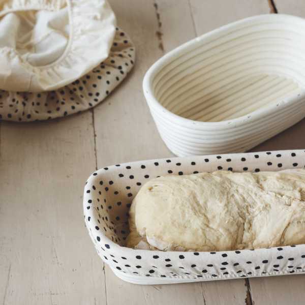 Bread dough proofing in a banneon basket lined with a Now Designs banneton basket liner