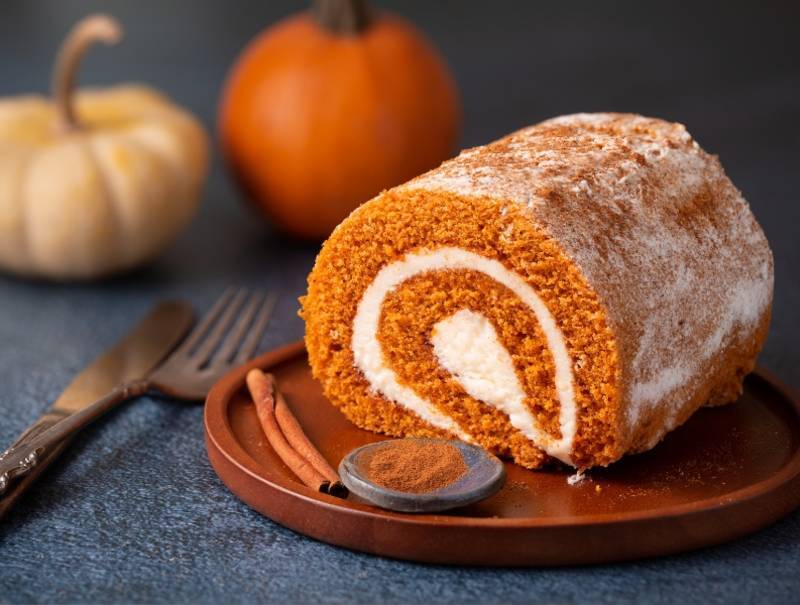 A pumpkin roll cake slice on a plate